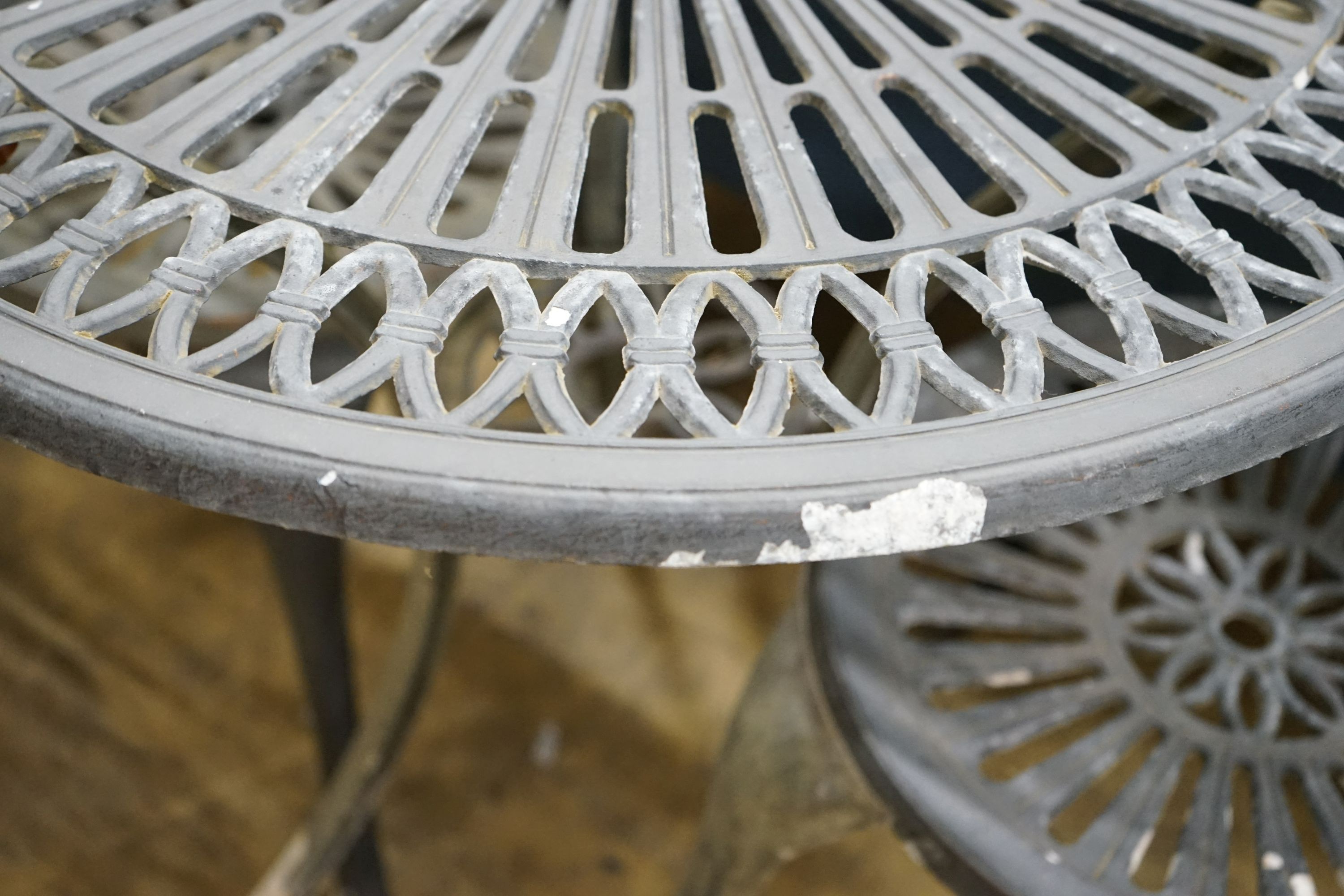 A circular aluminium garden table, diameter 69cm, height 67cm and two chairs
